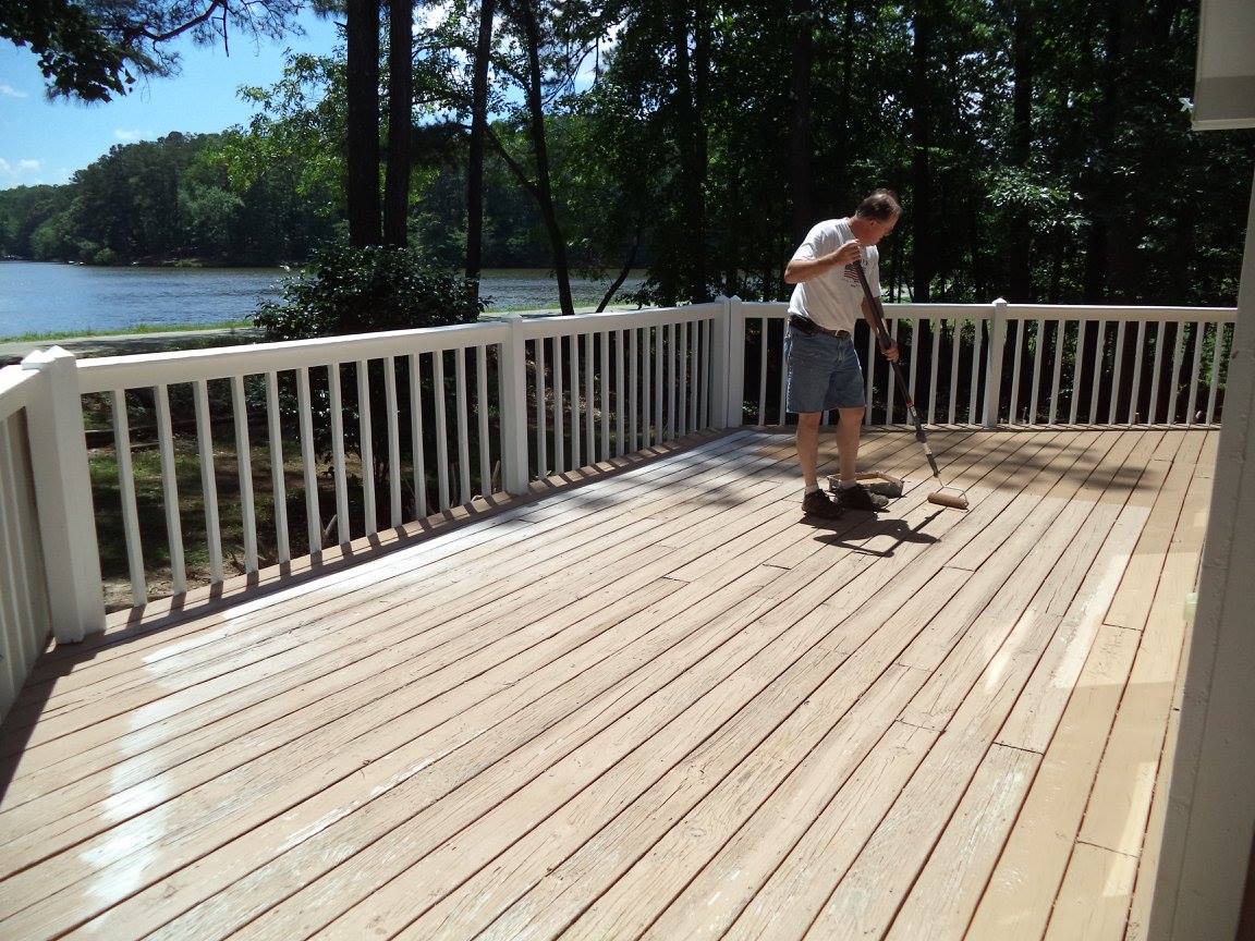 Painting a deck with a view over a lake